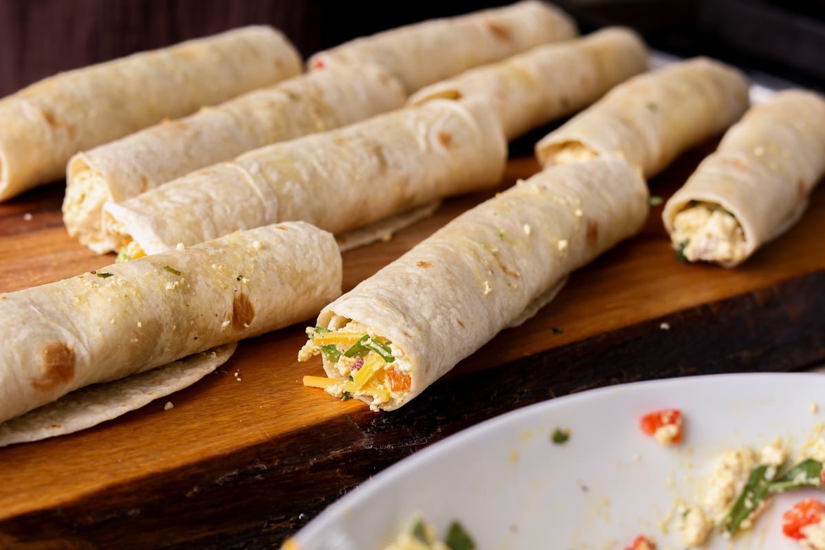 breakfast taquitos after rolling on the cutting board