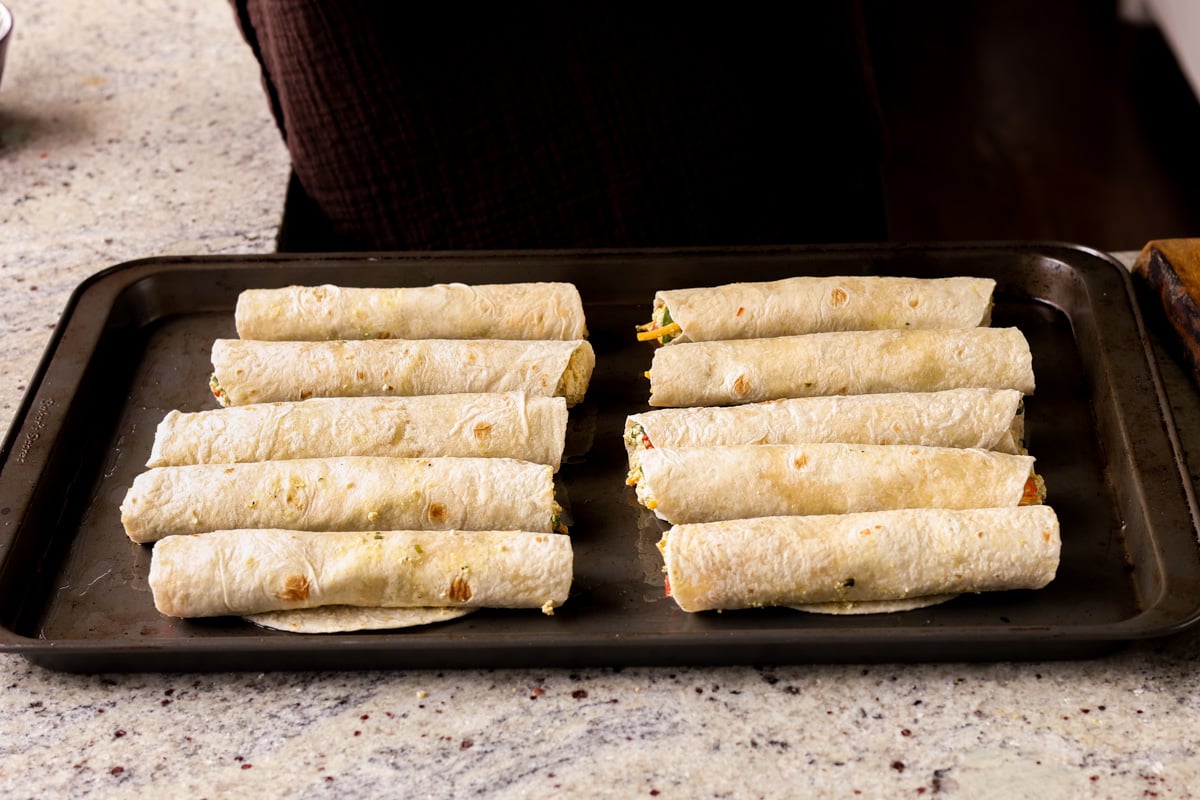 breakfast taquitos on the baking sheet before baking
