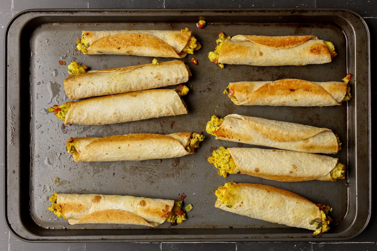 breakfast taquitos on the baking sheet after baking