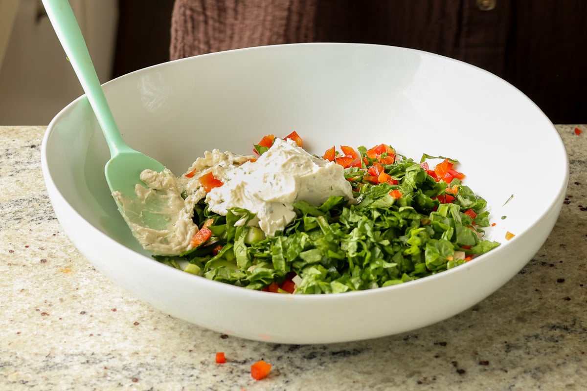 adding cream cheese and veggies to the tofu