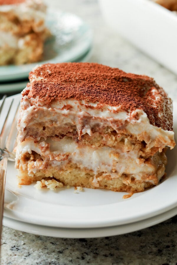 slice of chai tiramisu cake on a plate with a fork