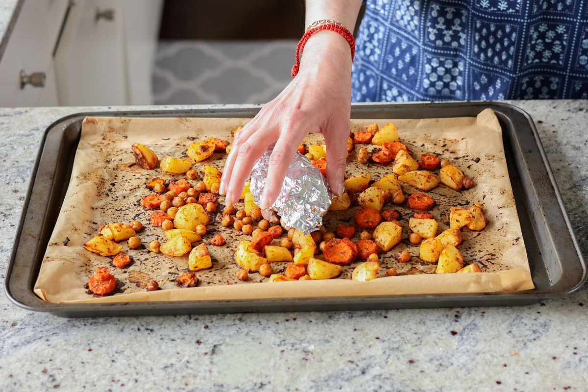 removing roasted garlic from the baking sheet