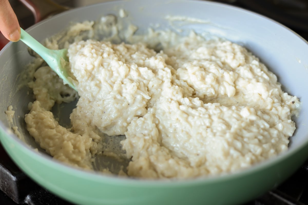stirring cashew cream into the rice