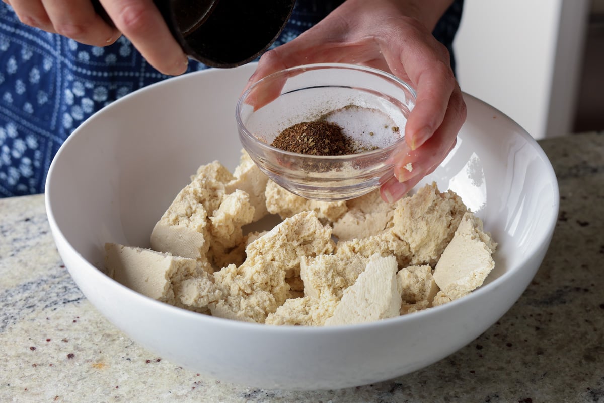 adding the spice rub to the tofu