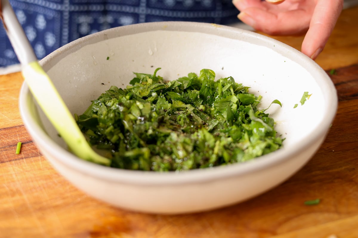 mixing the quick herb sauce together