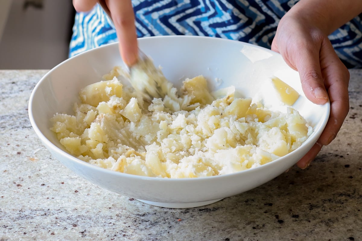 mashing the potatoes