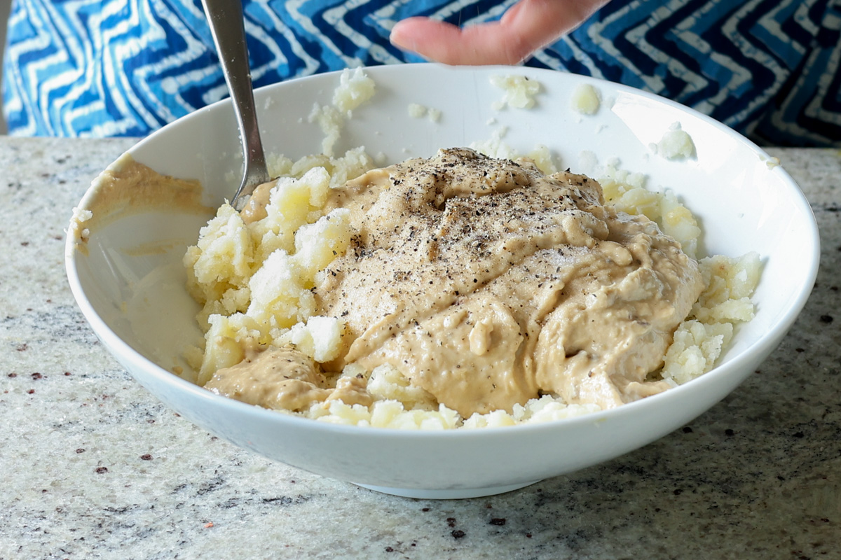 adding bean puree to the caramelized onion mashed potatoes