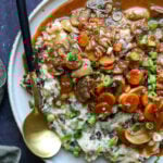 caramelized onion mashed potatoes on the plate topped with gravy