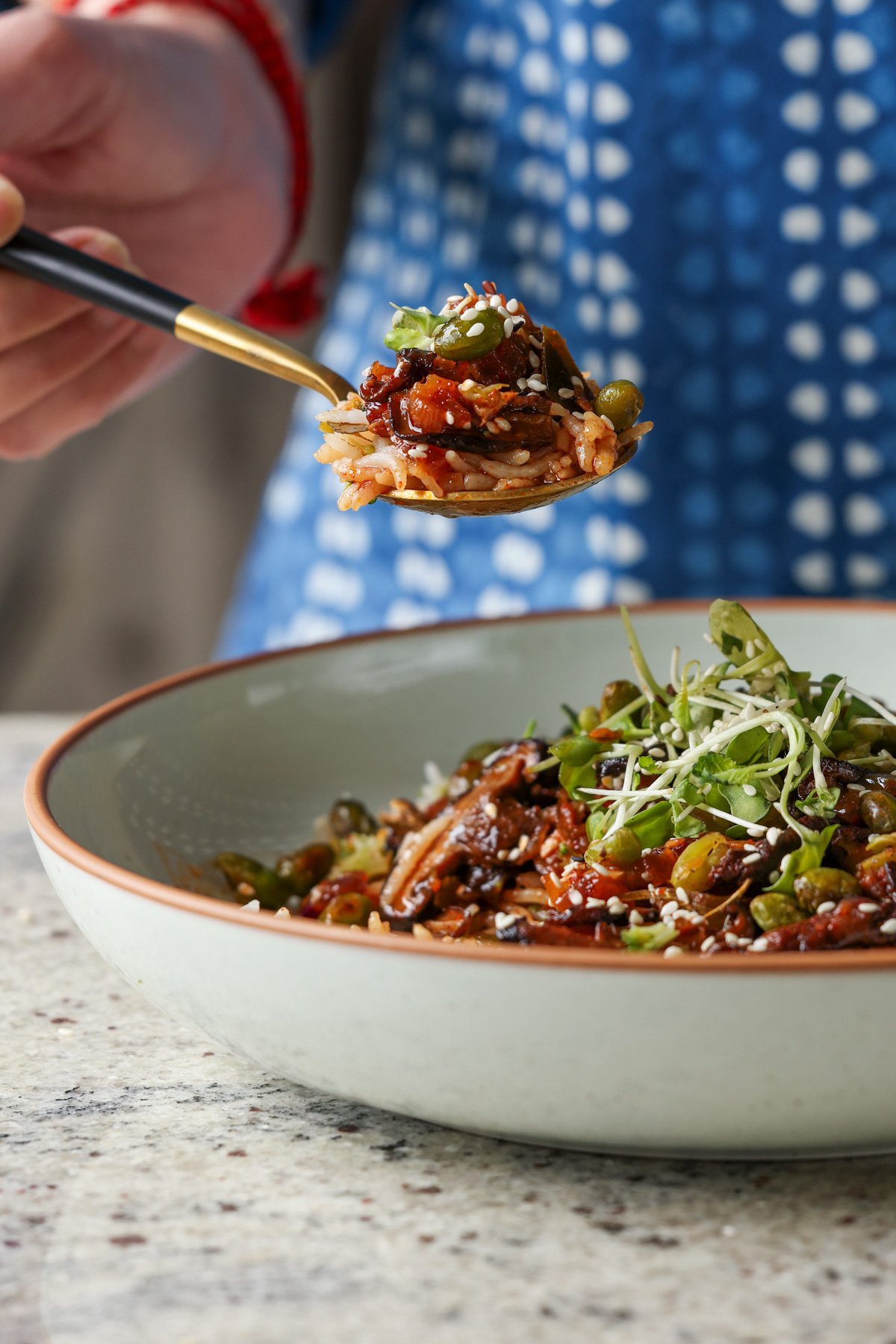 spoon taking a bite of crispy edamame bowl