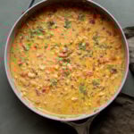 lemon white bean soup in the pan with garnishes