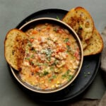 lemon white bean soup in a bowl with garlic bread