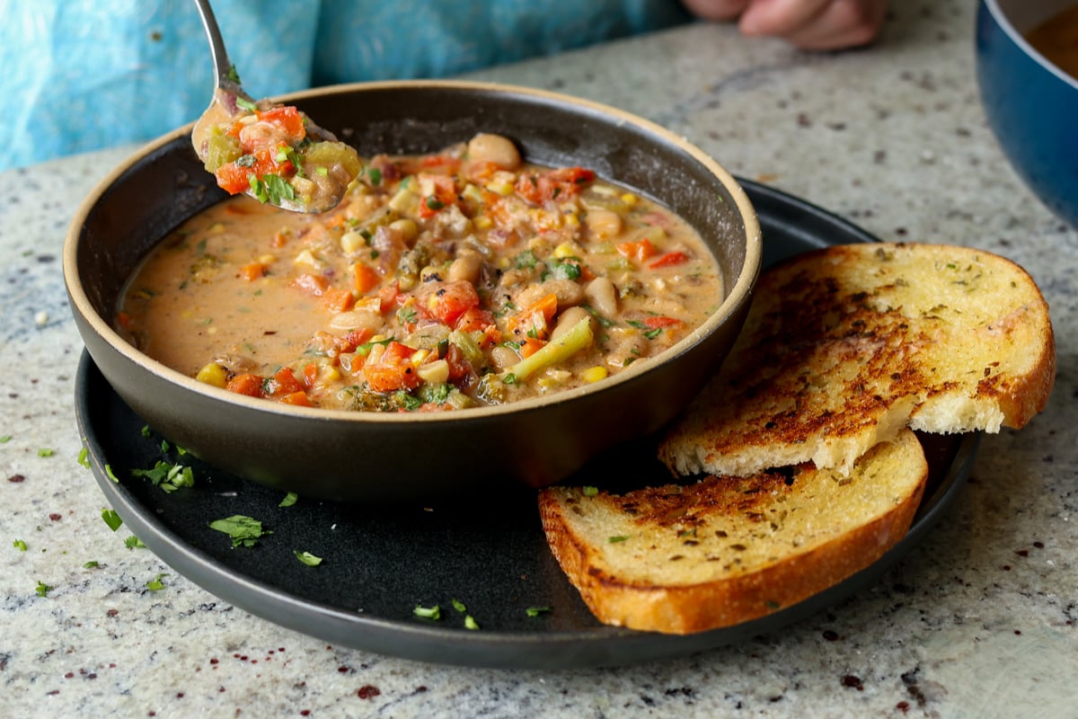 spoon taking a bite of lemon white bean soup