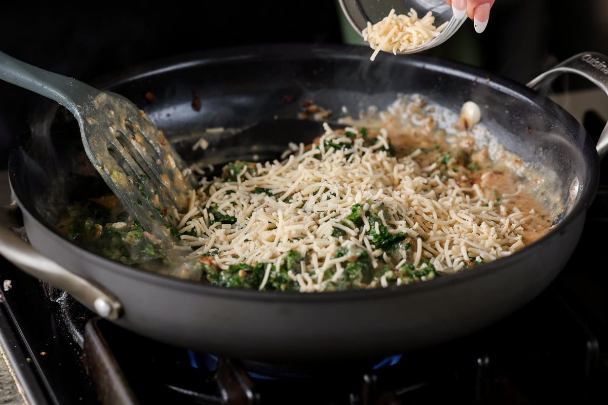 adding vegan parmesan to the pan
