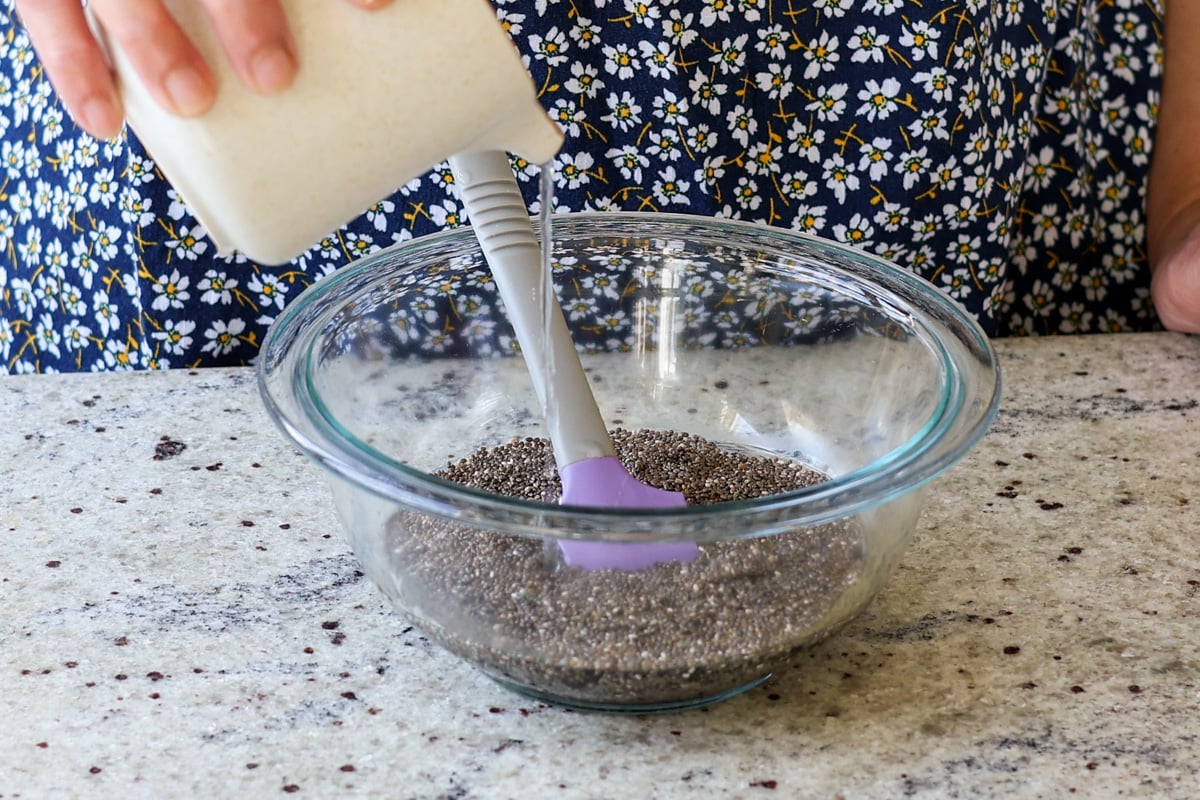 adding warm water to chia seeds