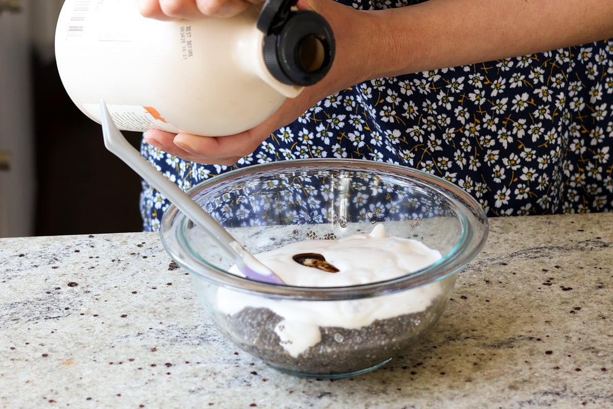 adding maple syrup to the chia pudding mixture