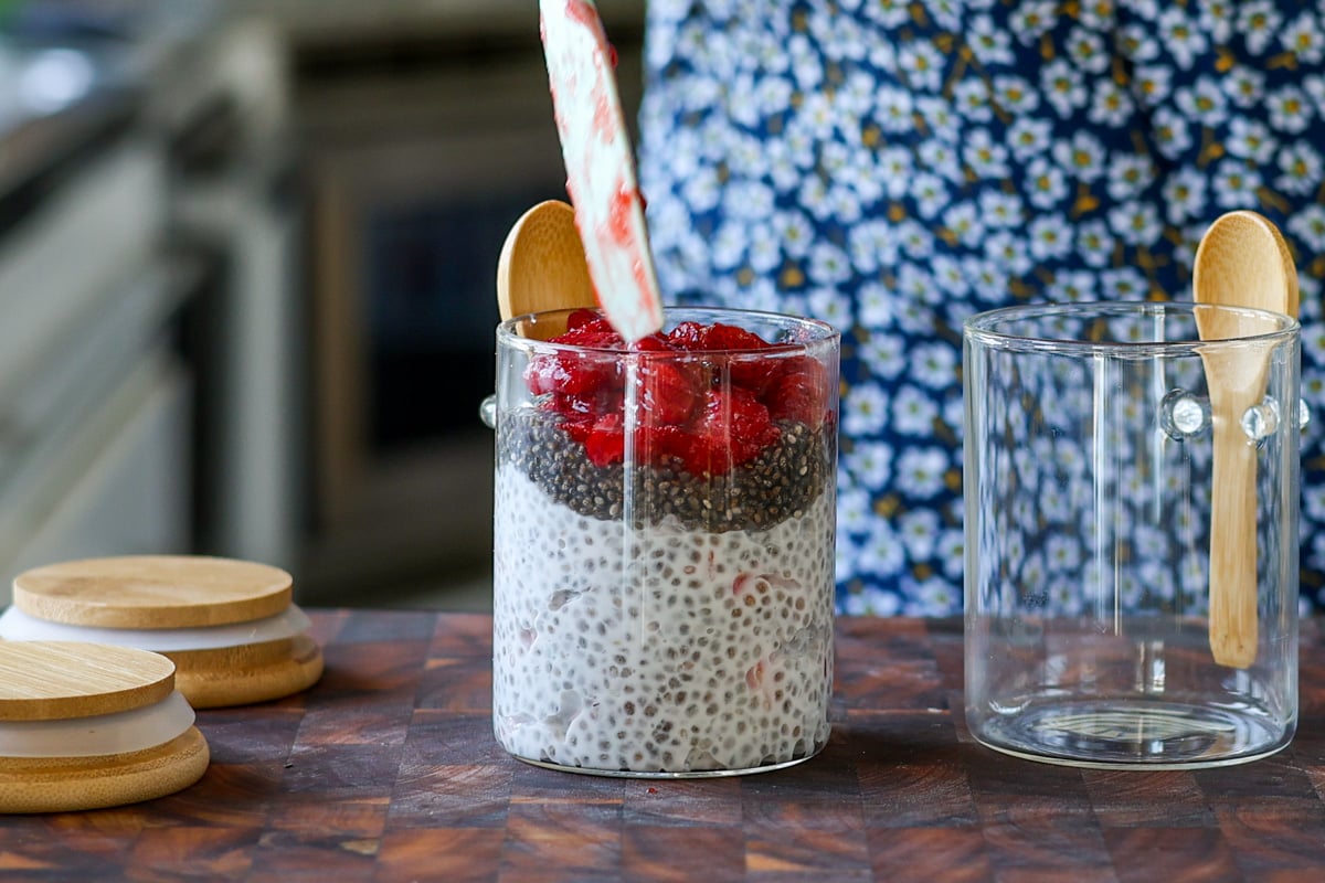 layering the strawberry chia seed pudding in a jar