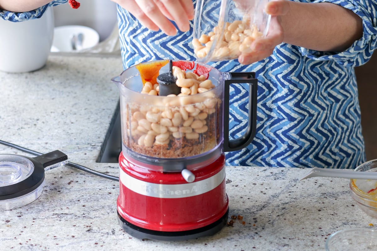 adding white beans to the food processor