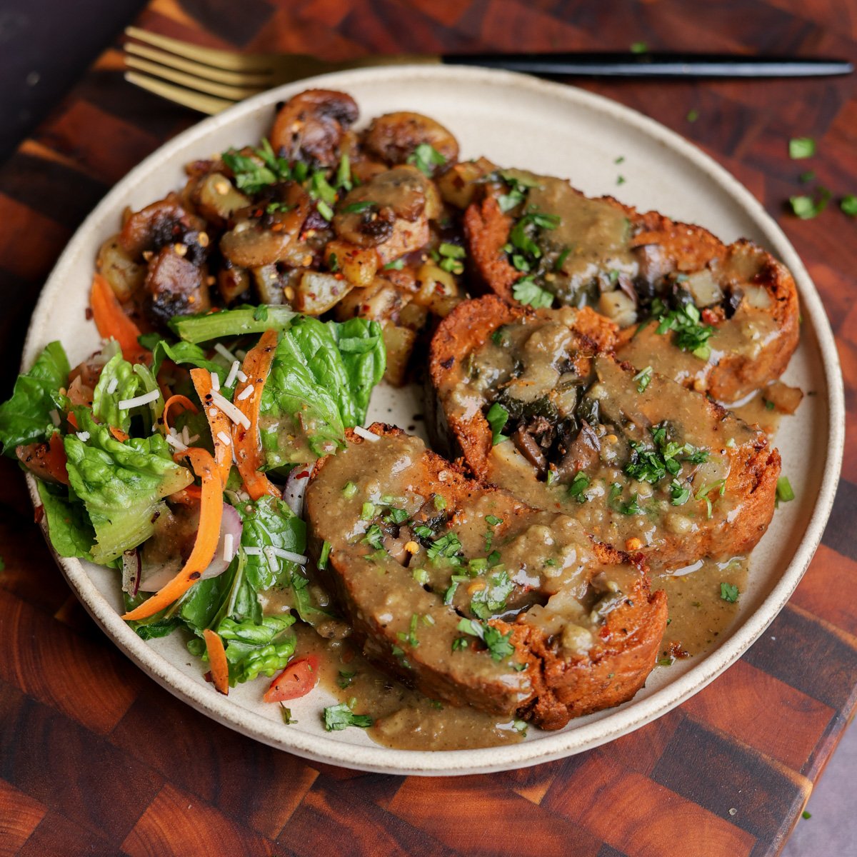 sun dried tomato roast on a plate with salad and mushrooms