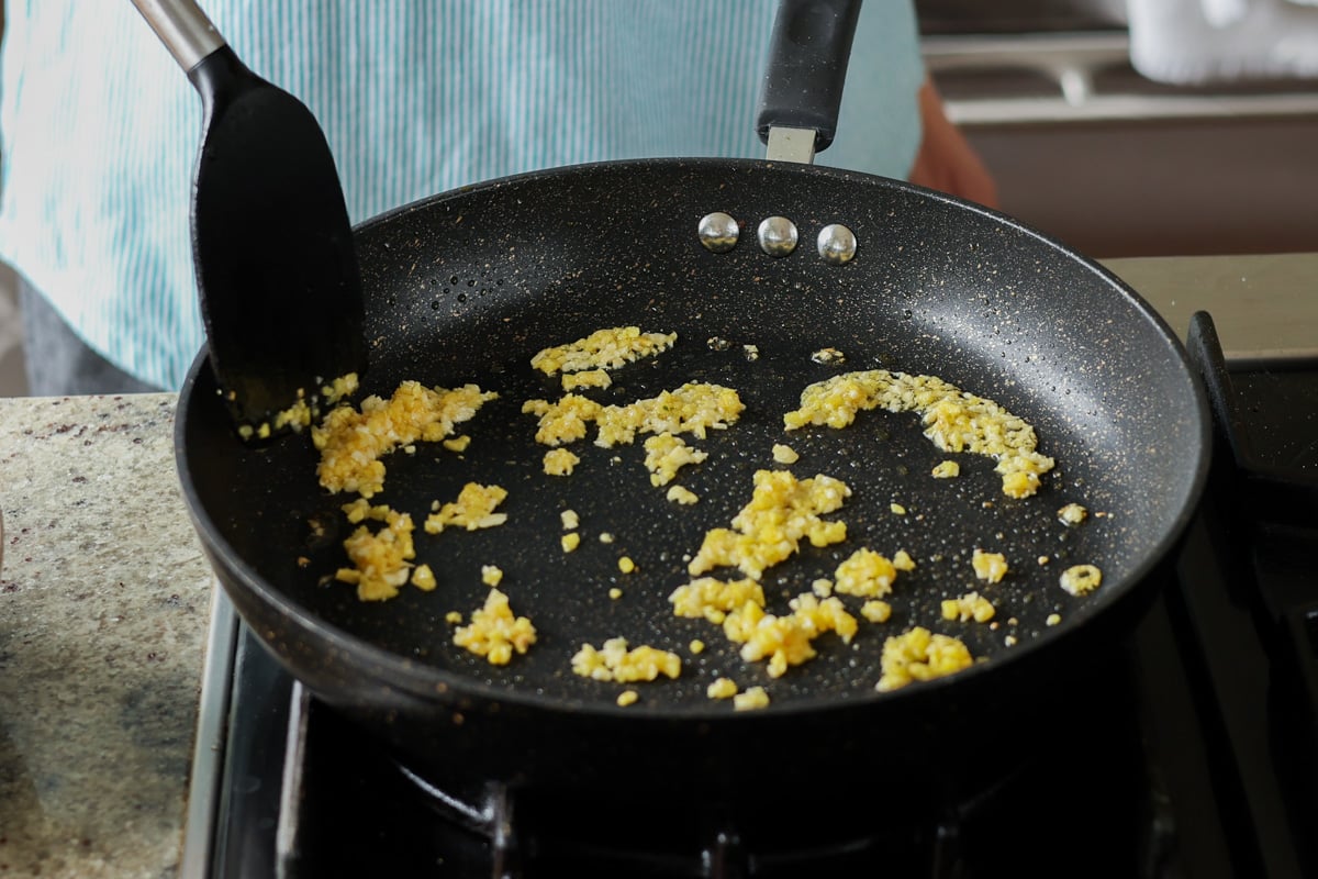 adding ginger and garlic to the pan