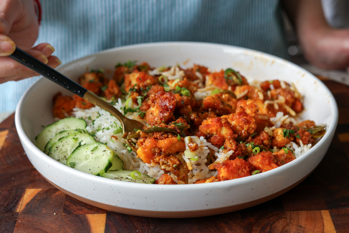 apollo tofu on a plate with rice and cucumber