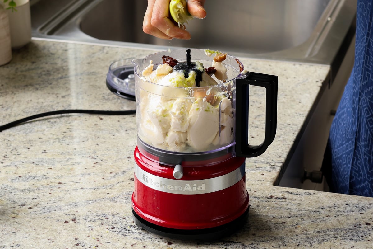 adding chipotle whipped tofu ingredients to the food processor