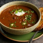 kidney bean chili in a bowls with vegan sour cream and other toppings