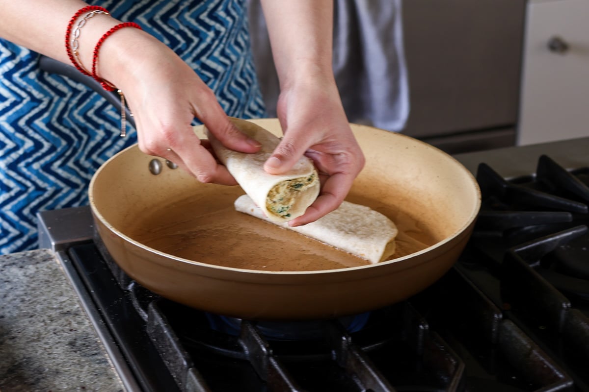 adding the ricotta tacos to the frying pan