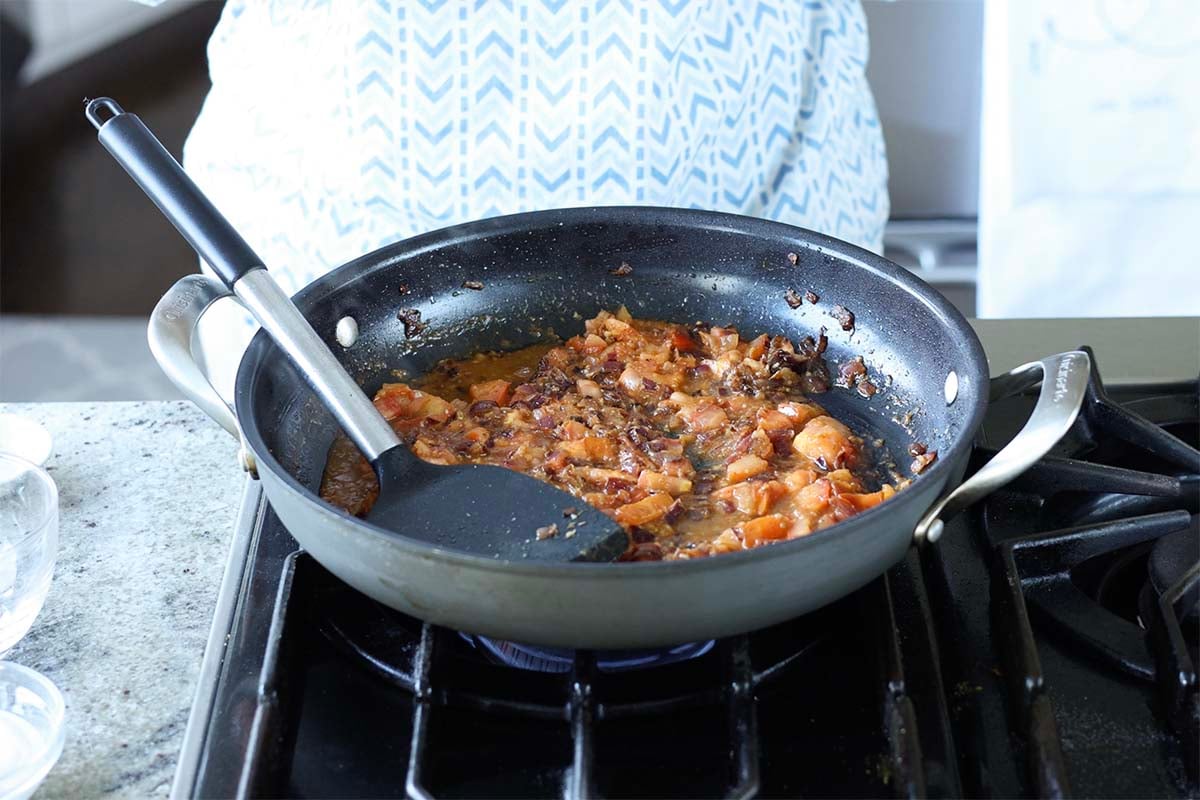 mashing the tomatoes