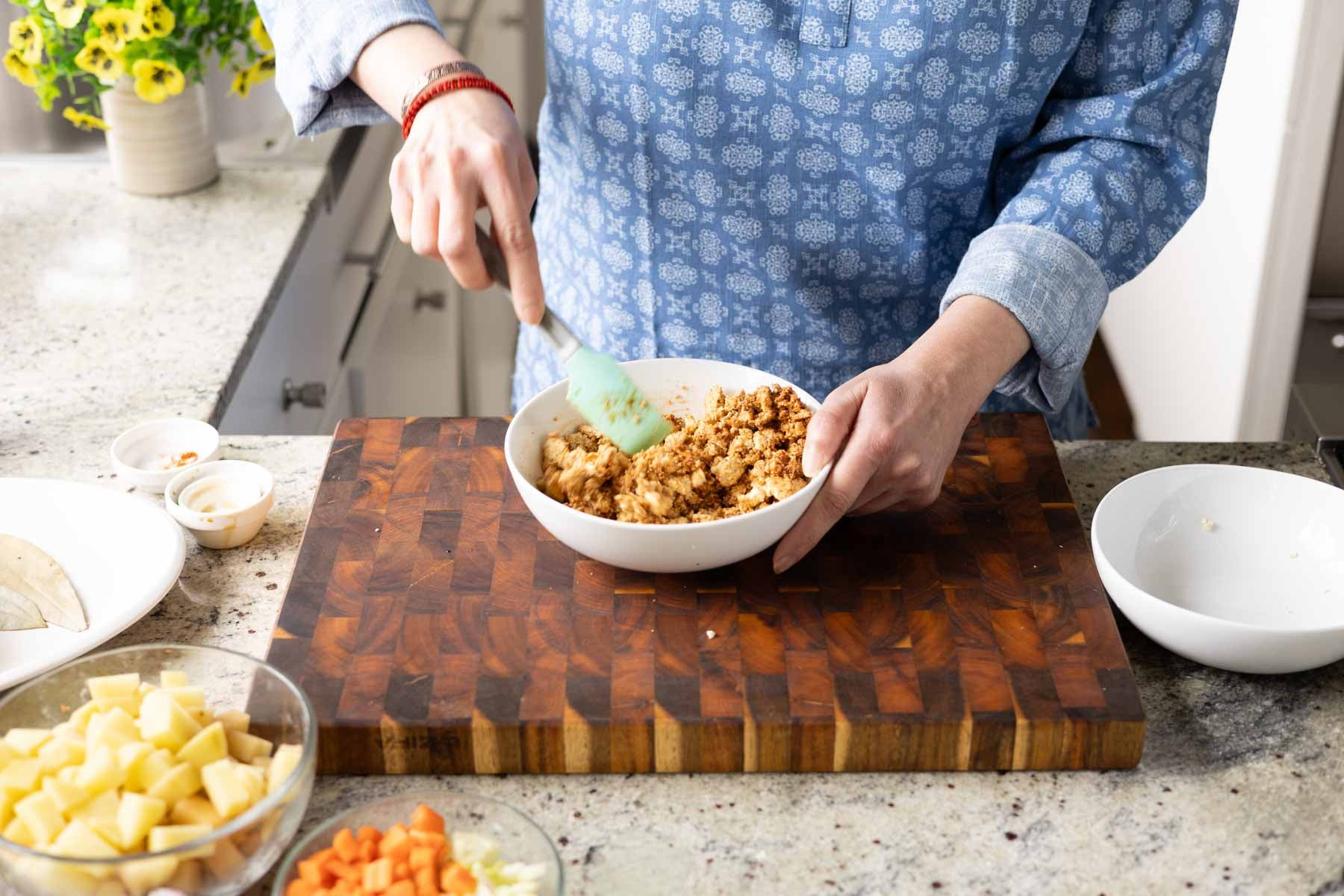 tossing the tofu in the marinade
