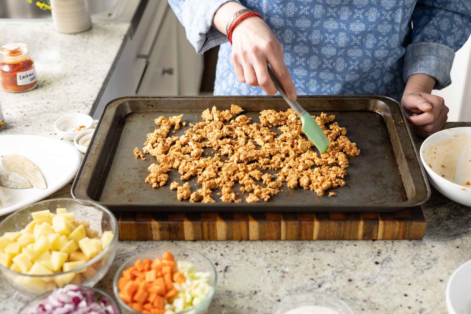 spreading the tofu onto a baking sheet