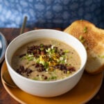 corn chowder in a bowl with all the toppings