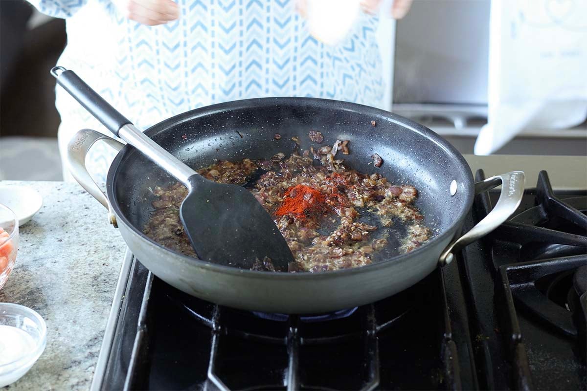 adding spices to the pan
