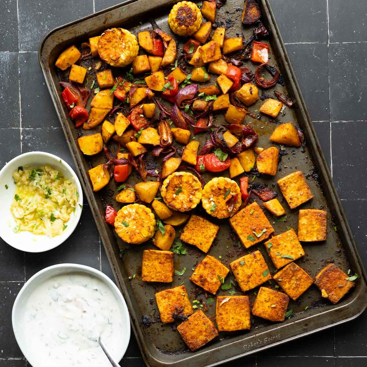 peri-peri tofu and vegetables on the sheet pan after baking