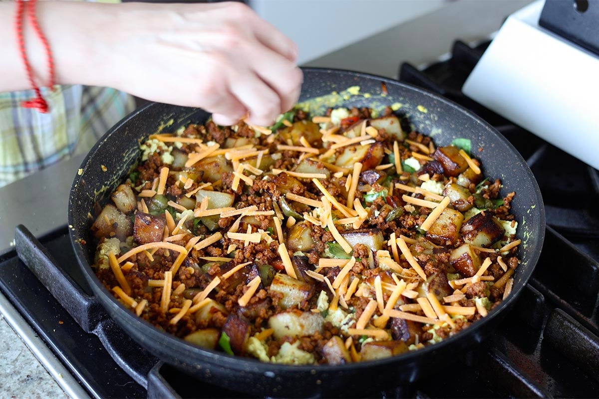 adding cheese to the skillet