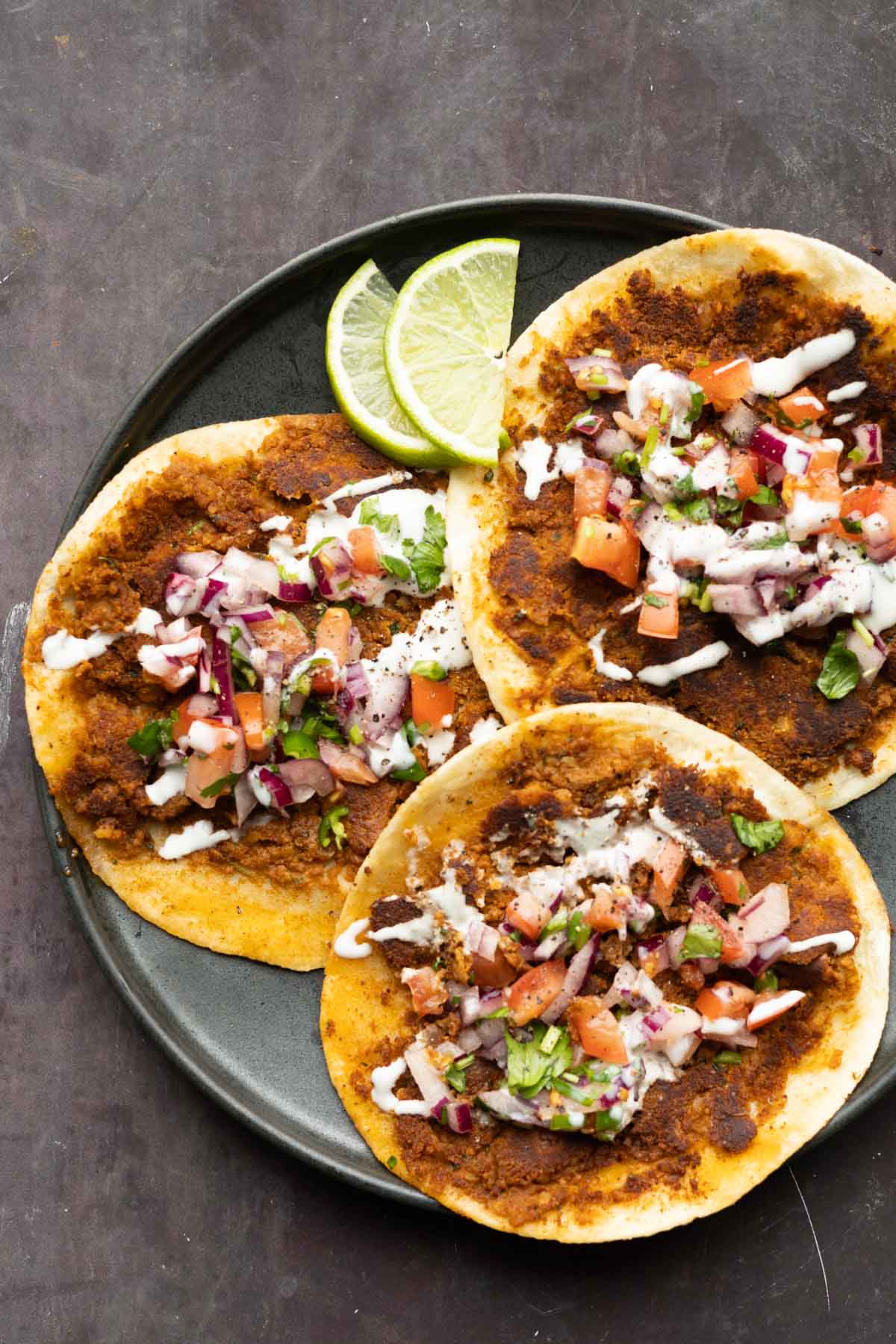 chickpea mushroom smash burger tacos on a plate with lime and toppings