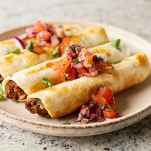 chickpea mushroom taquitos on a plate with pico de gallo