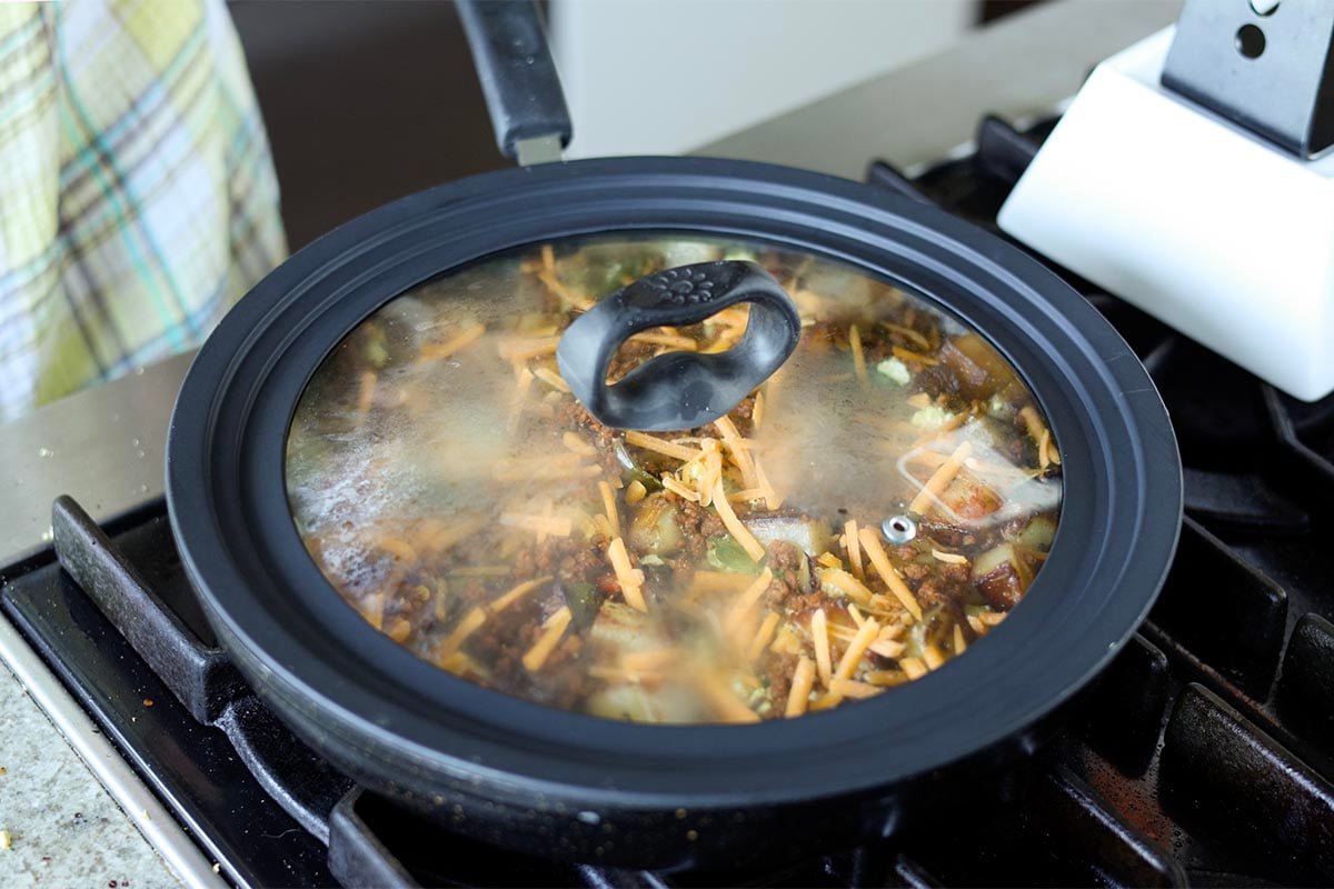 covering the skillet to melt the cheese
