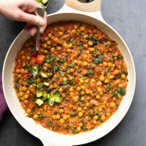 adding the salsa to the peri-peri chickpeas in the pan after cooking