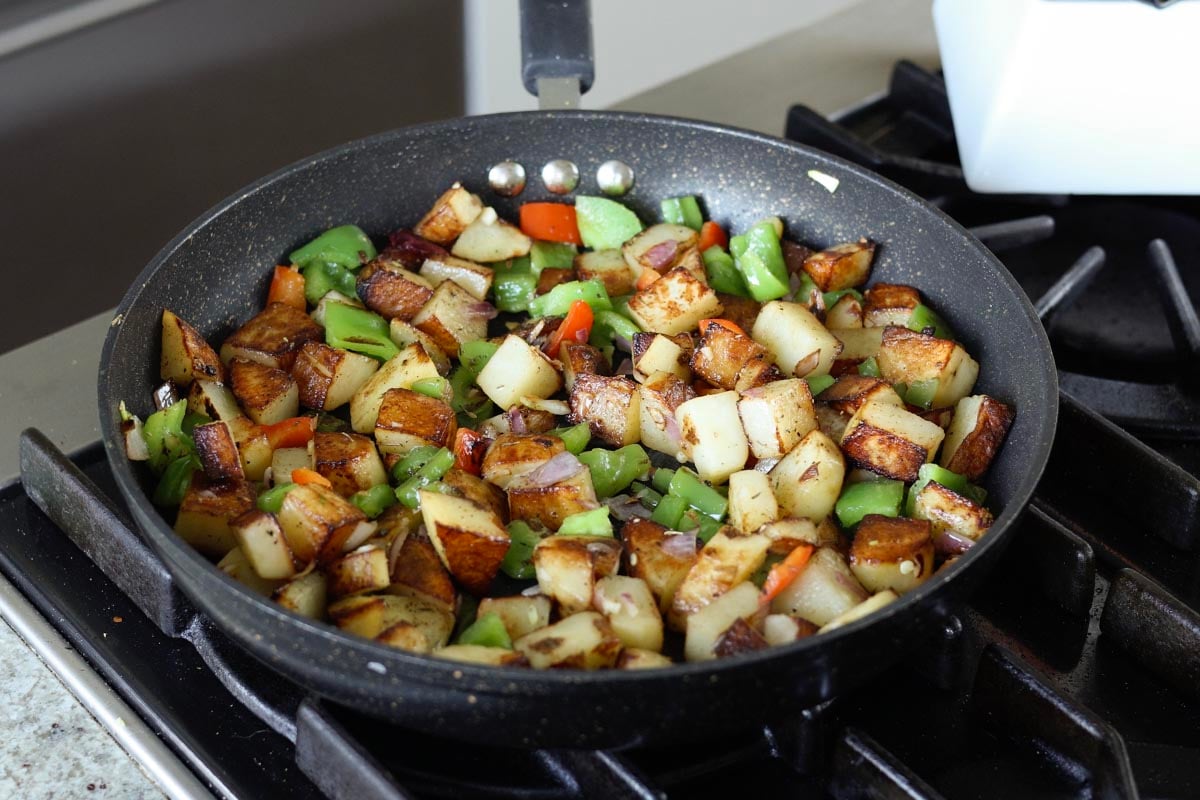 potatoes and veggies in the skillet after cooking