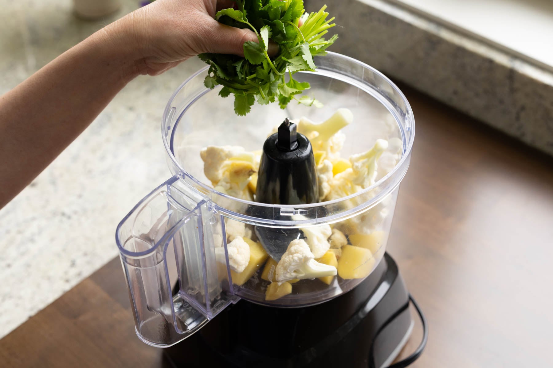adding veggies to the food processor