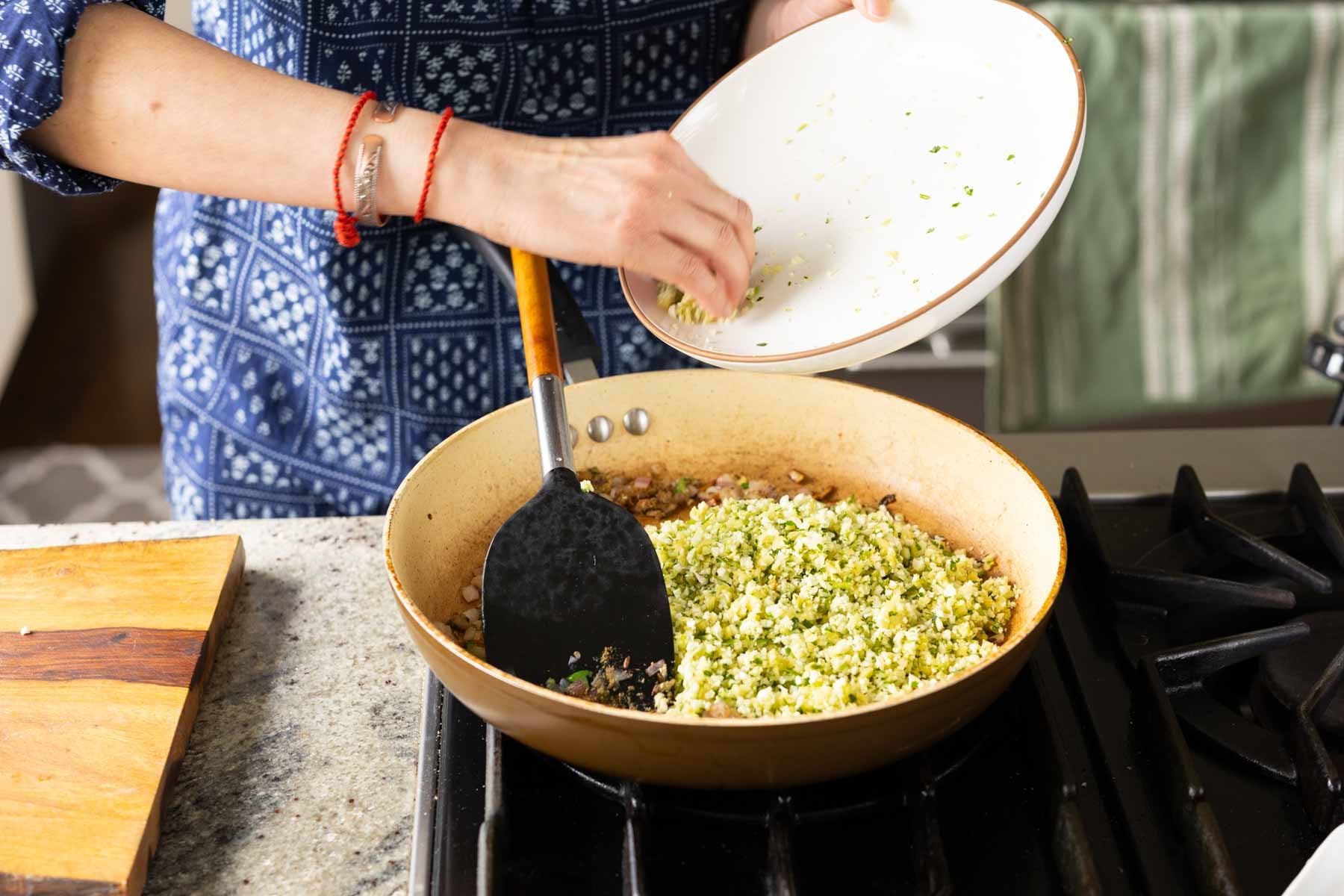 adding the processed veggies to the pan