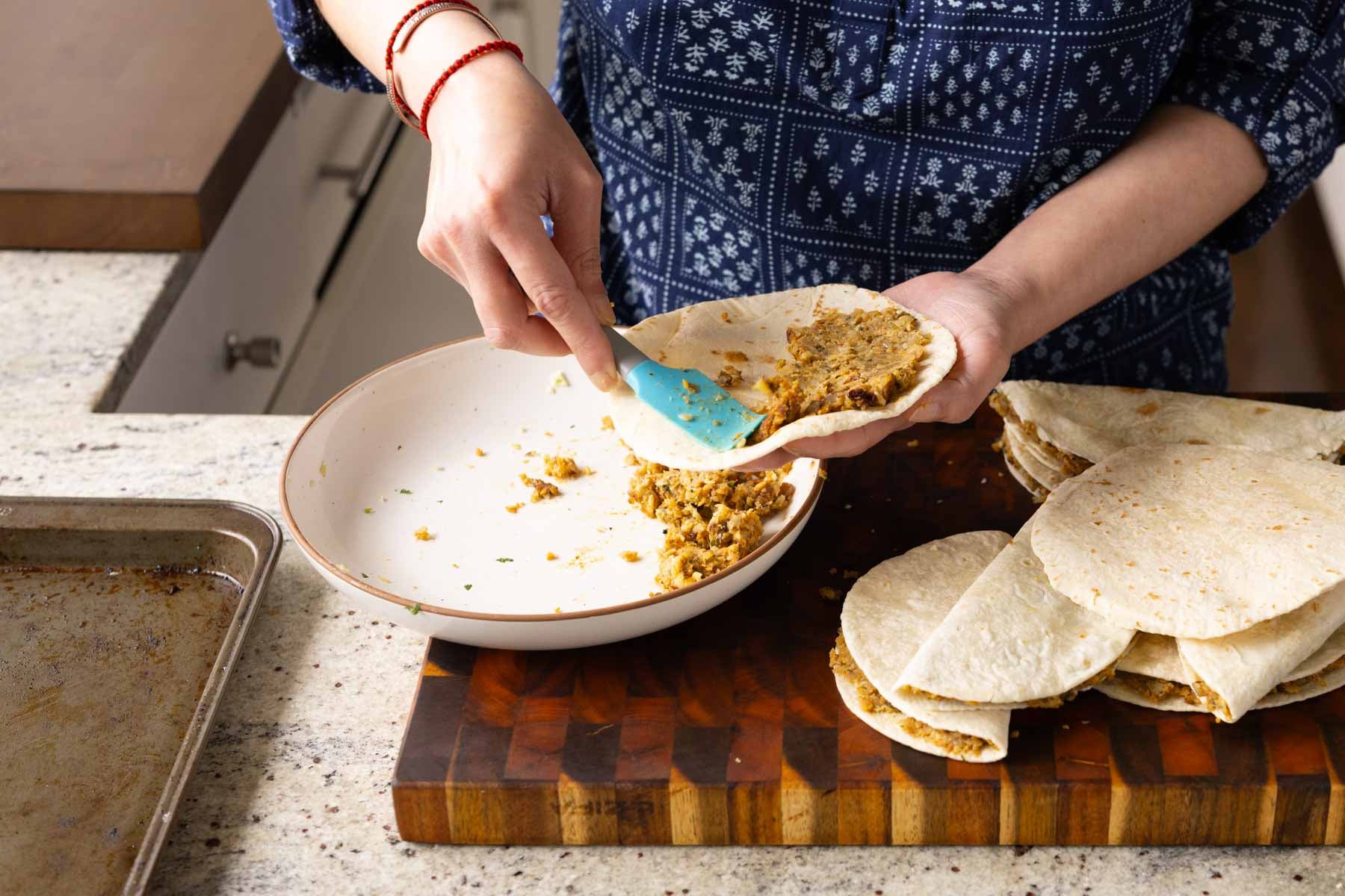 filling a tortilla with paratha filling