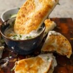 dipping a paratha taco into raita
