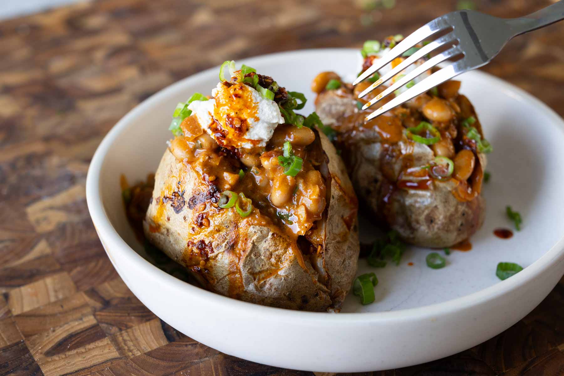 baked potatoes topped with the chili garlic beans