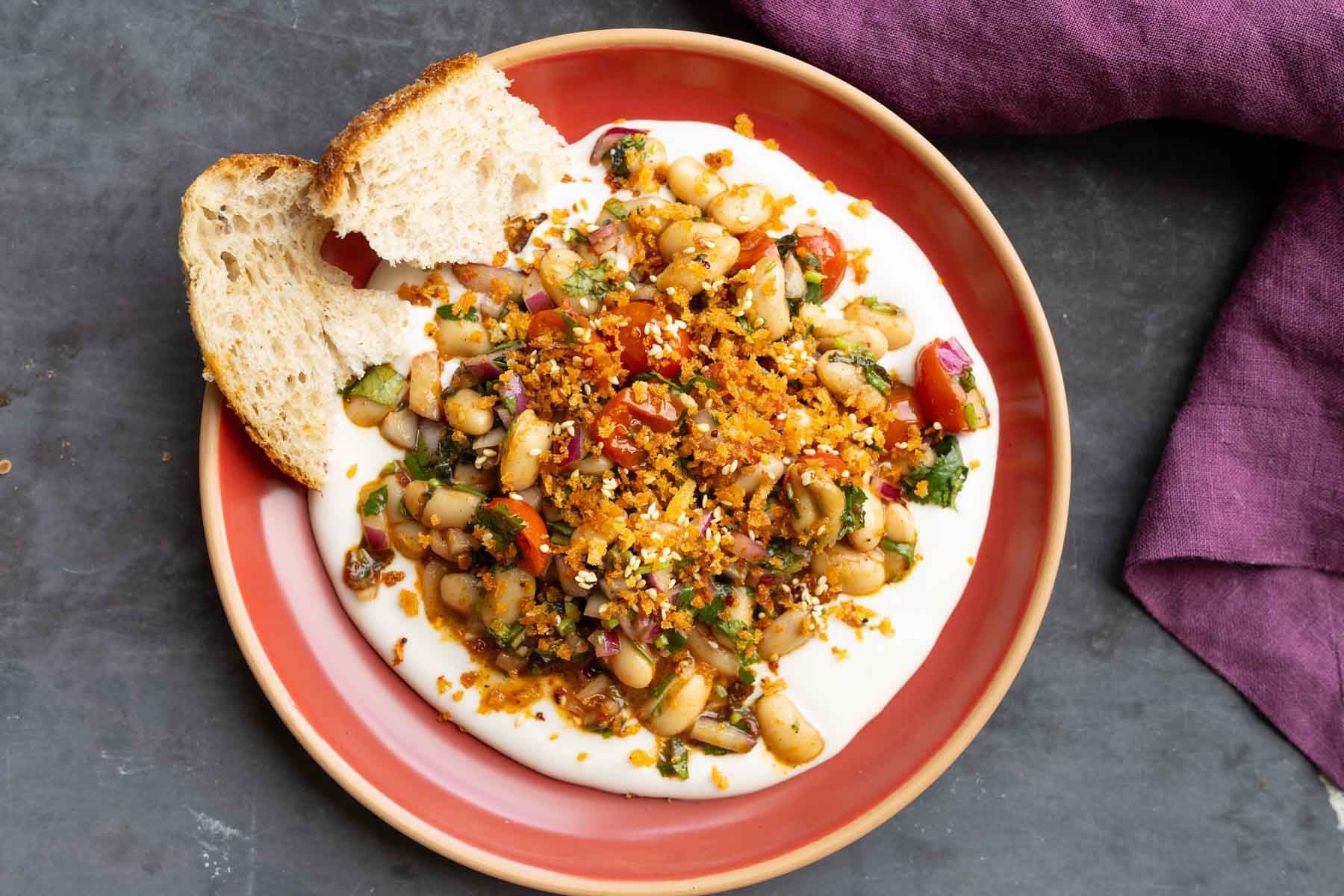 marinated white bean salad served over hummus with bread