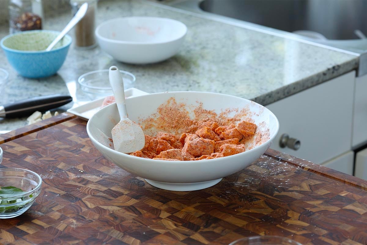 tofu pieces in the bowl, coated in the spice mixture