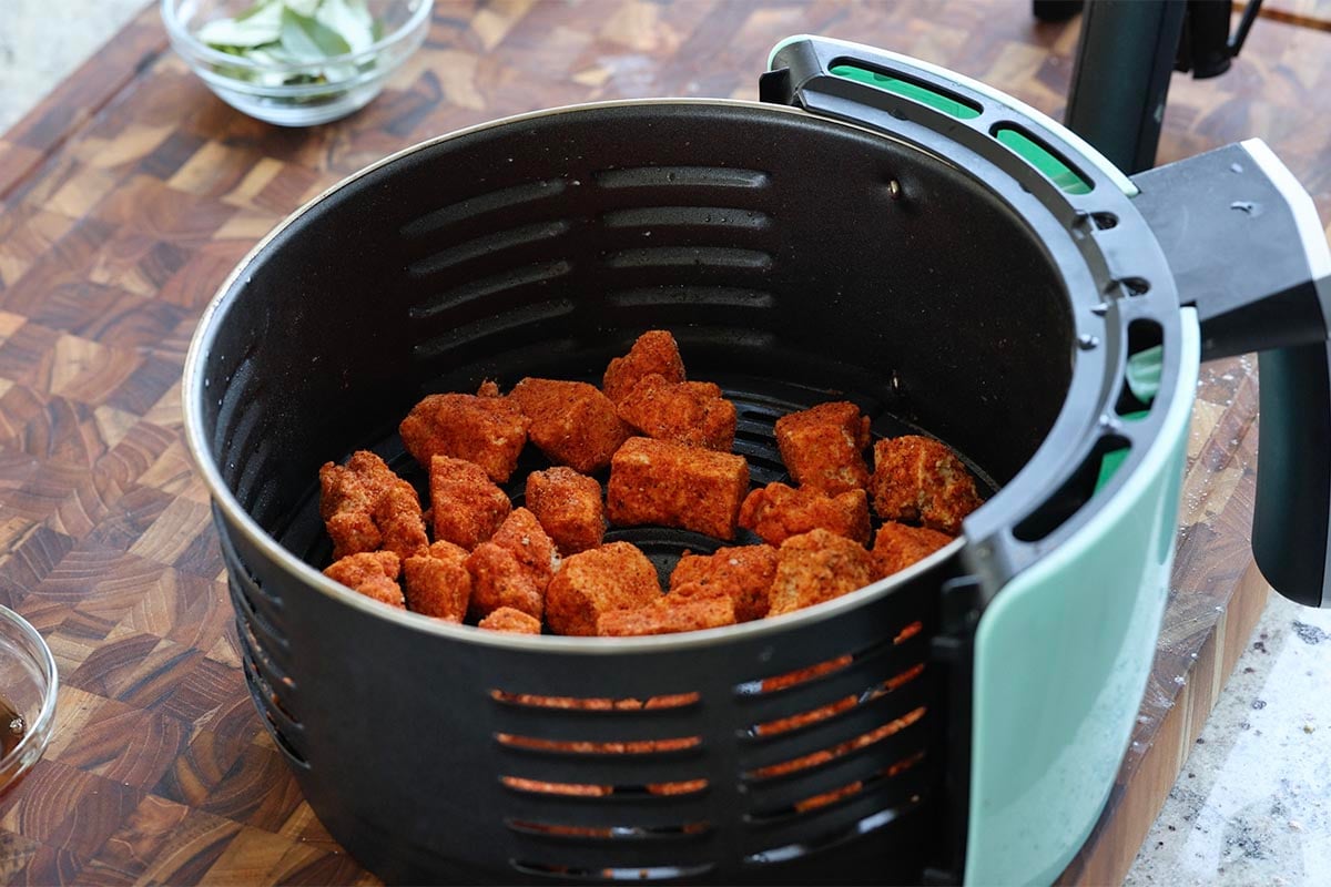 adding the tofu pieces to the air fryer