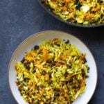 bowl of sambharo-inspired cabbage salad next to the pan