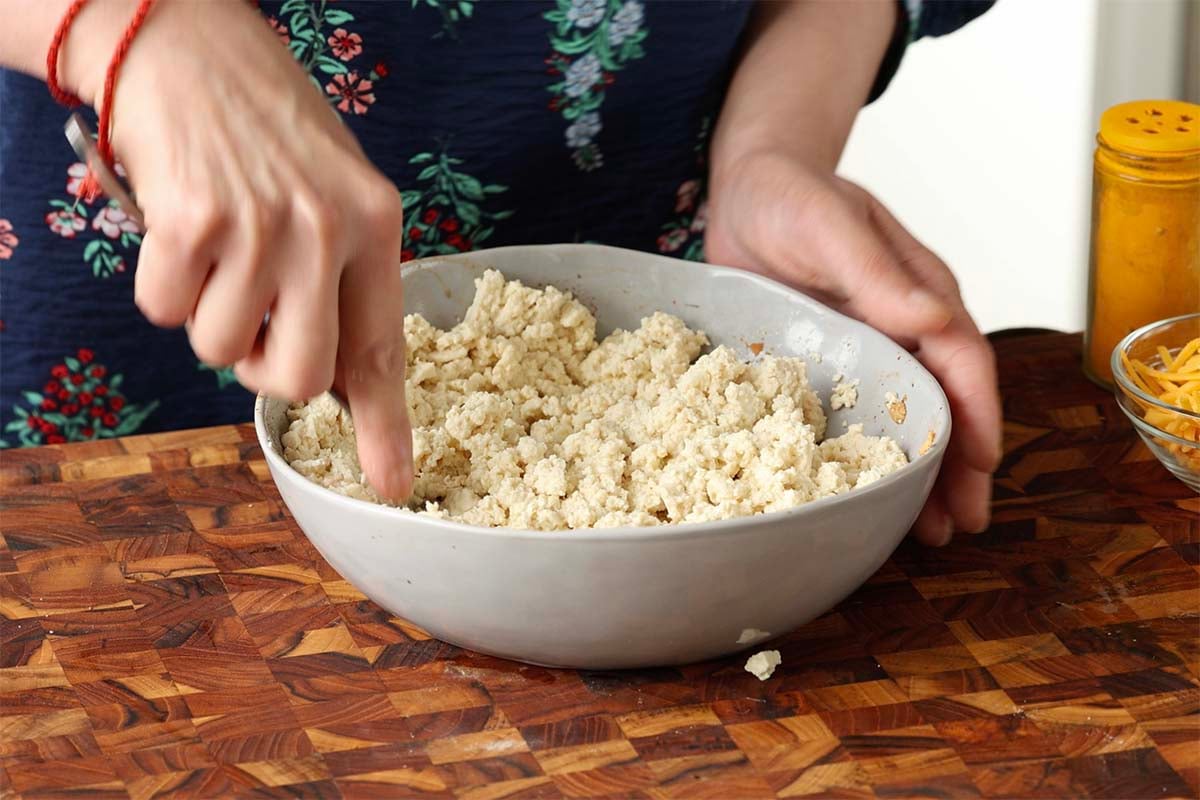 mashing the tofu in the bowl