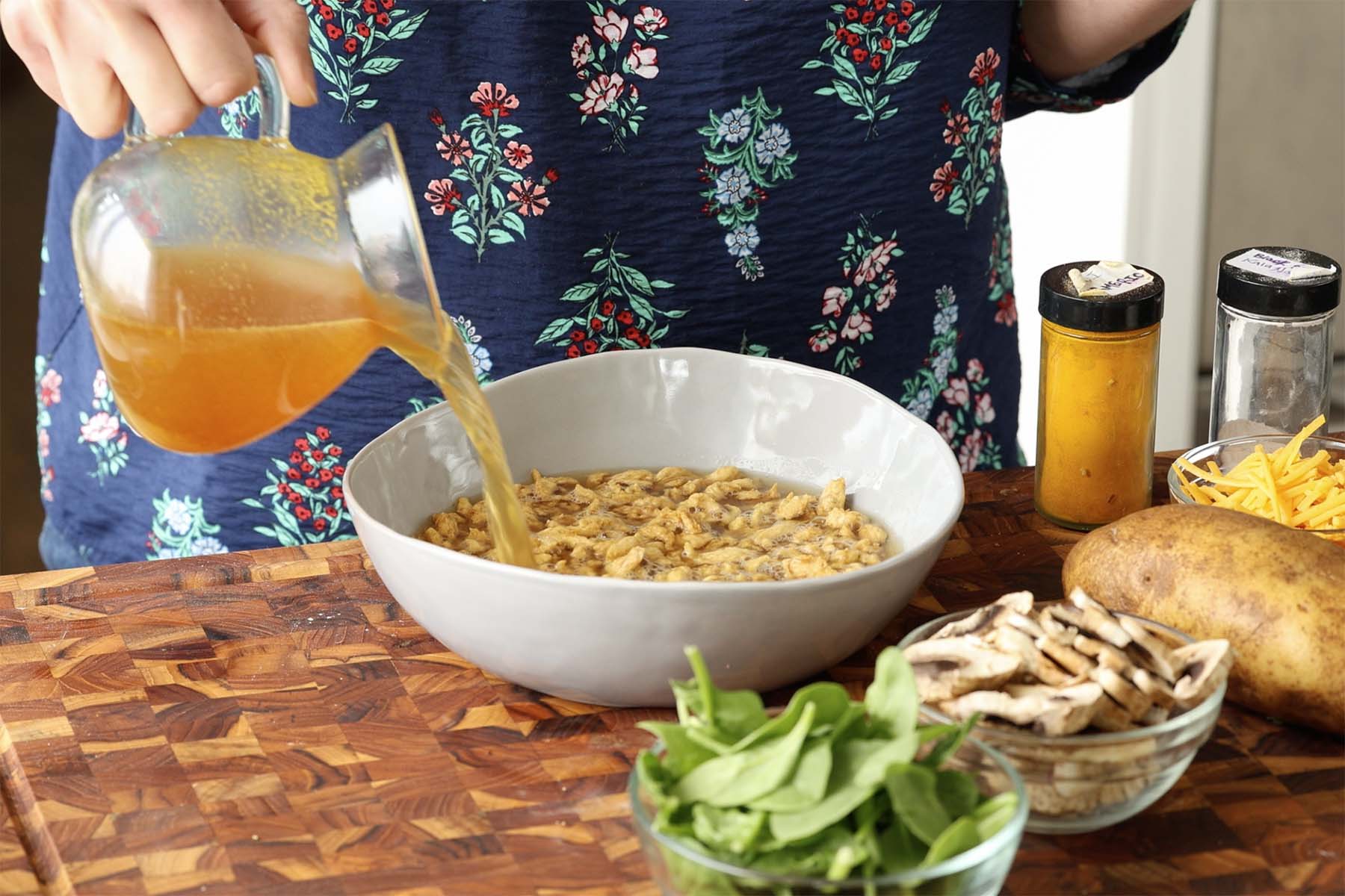 adding hot broth to the soy curls